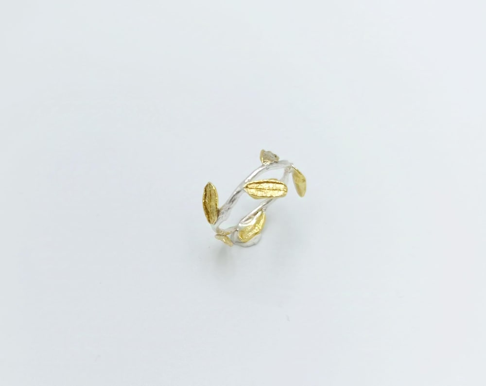 A ring with a leaf design on a white background.