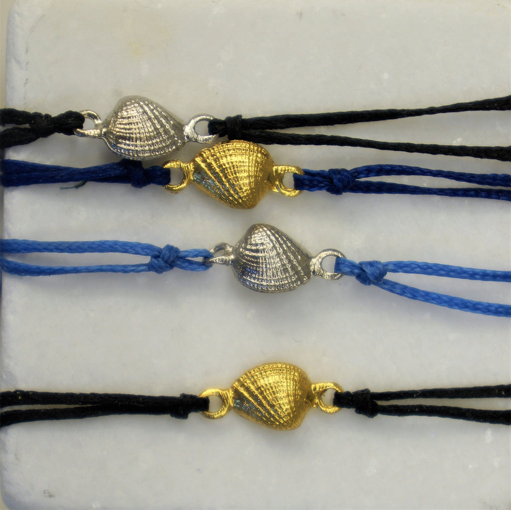 a collection of colorful beaded bracelets with metal clasps, arranged in a row on a white surface.