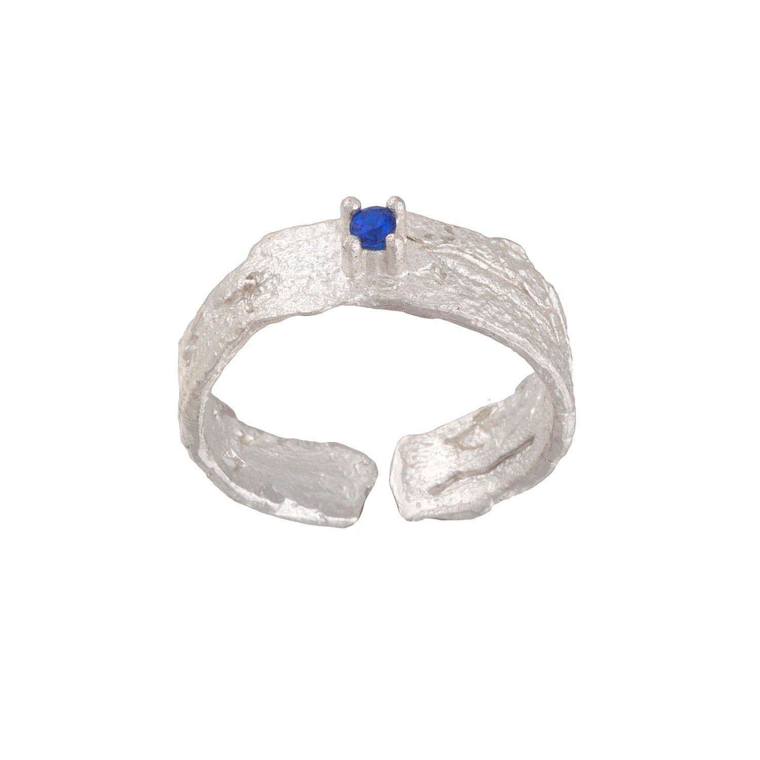 A silver ring with a blue gemstone, possibly a sapphire, set in the center.